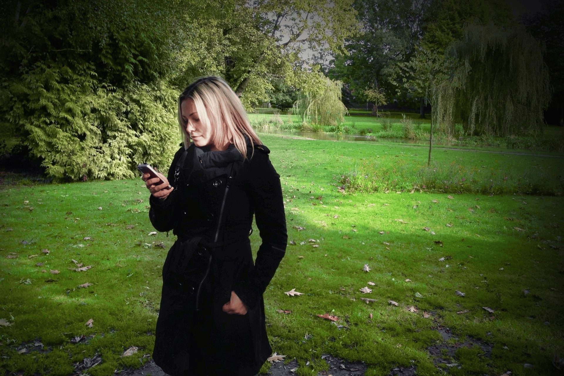 A woman on her phone searching for a tree surgeon near me